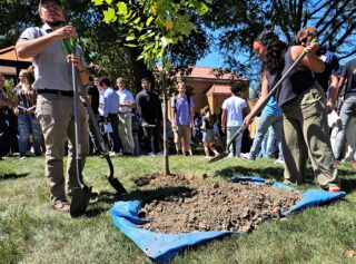Assisted by Groundskeeper Ben MacDonald, student planted a tulip tree along with their intentions for their time at Clarke.