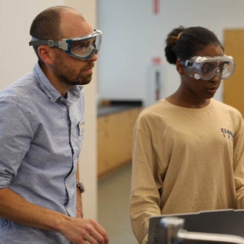 A male teacher discussing the results of an experiment with a student.