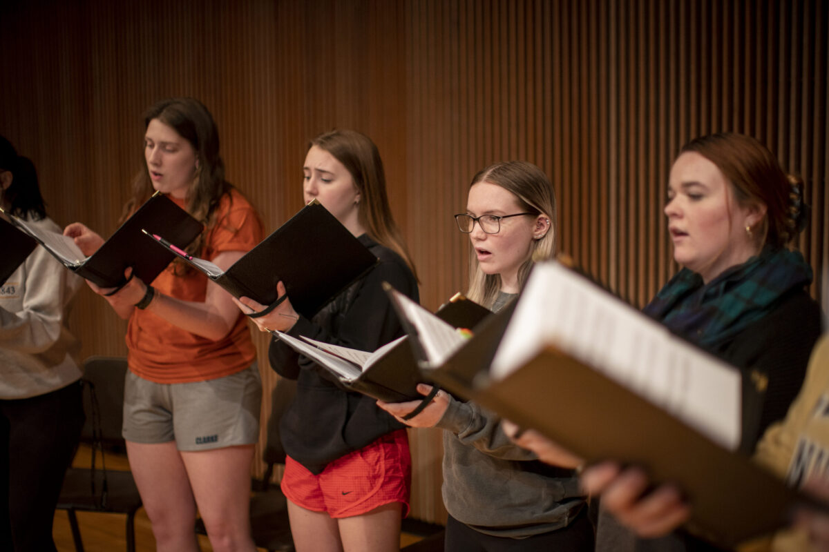 A group of female students singing in a choir. - Full Size
