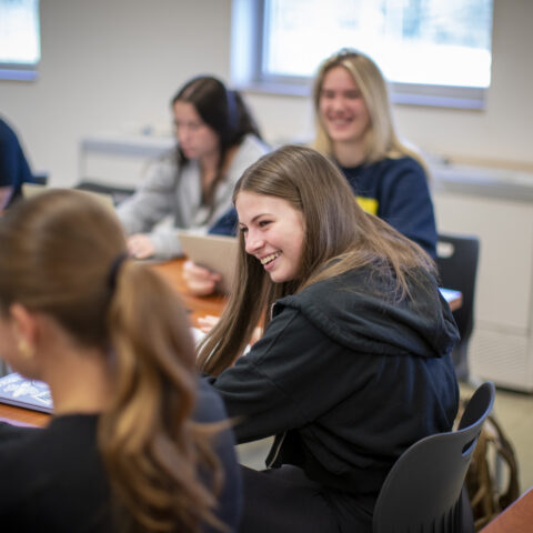A female student smiling in class.