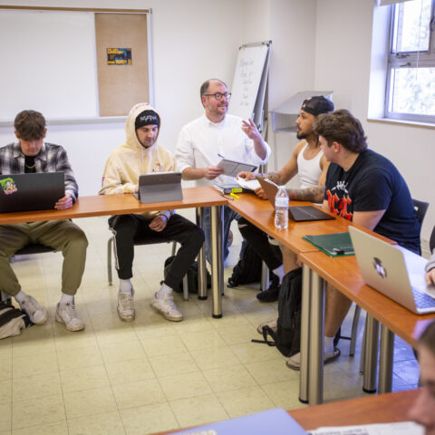 A male teacher telling his students the assignment.