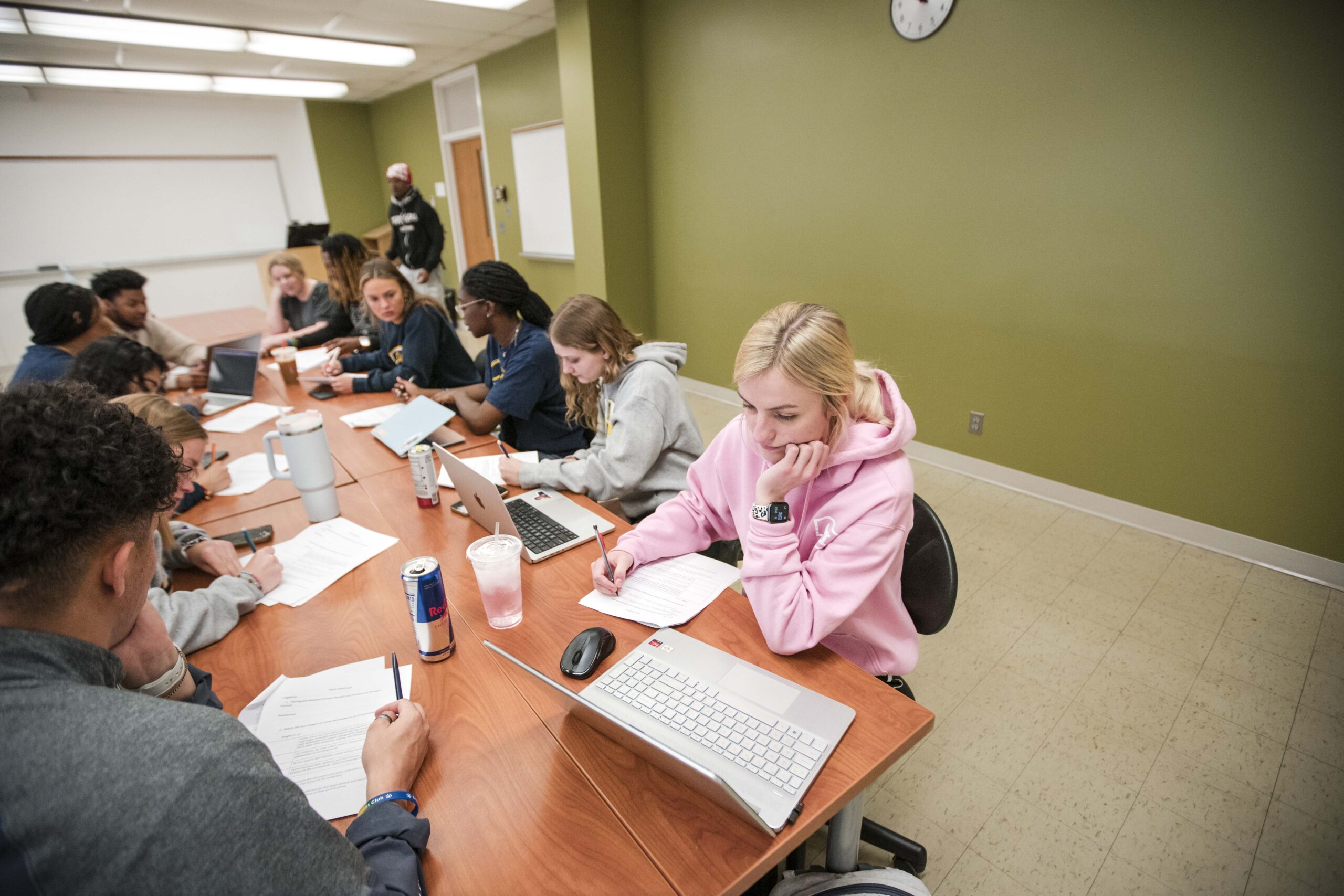 Clarke University students in a class researching during lecture.