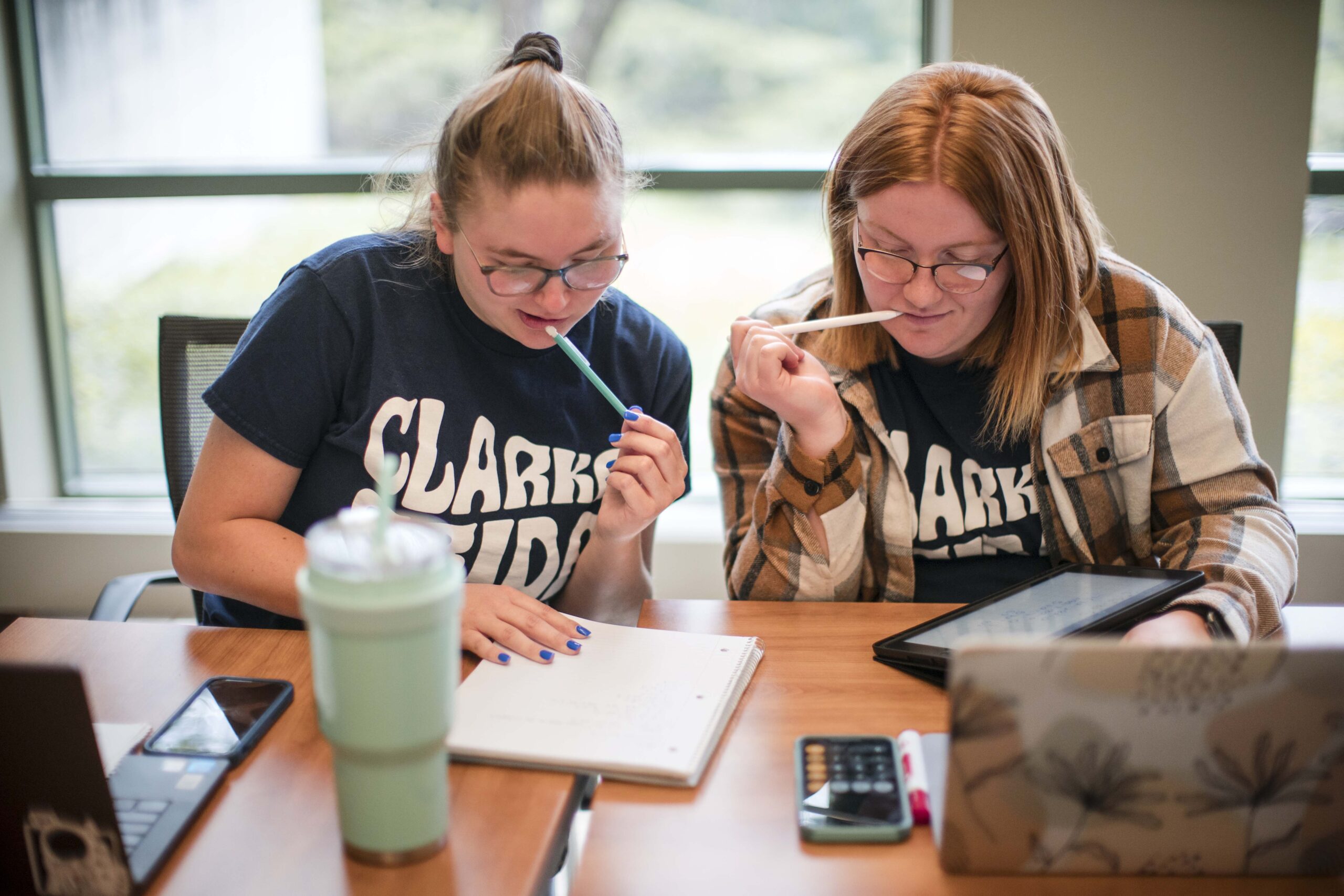 Clarke University students in class listening to lecture by professor.