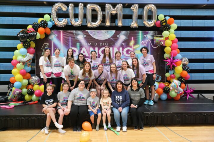 Students from the Dance Marathon student organization gather on stage.