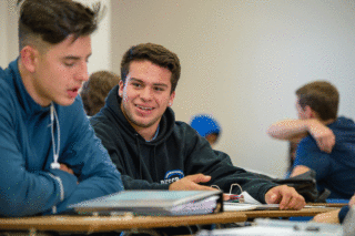 Students in Clarke's business administration degree in class working together