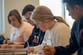 Students in Clark University's Business administration program taking notes