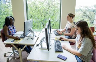 Clarke student working on her Communication Degree project in a computer lab