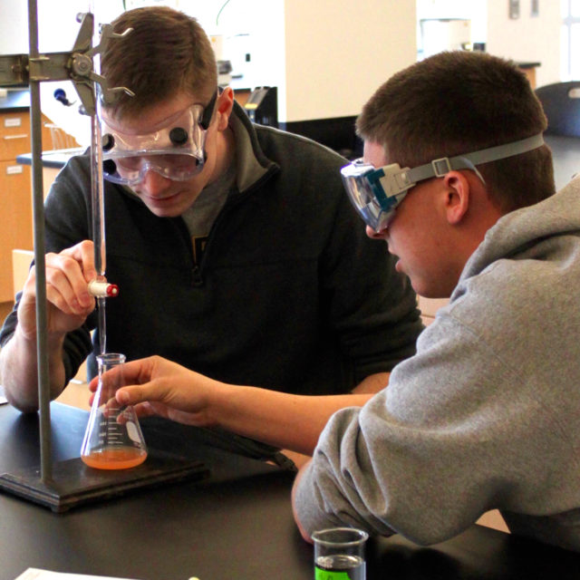 Two chemistry degree program students at Clarke University