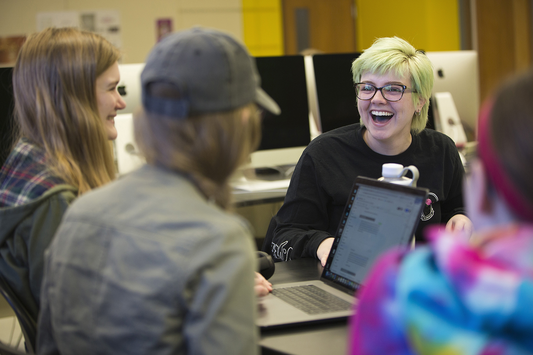 Clarke University Communication Degree students in engaging while working on a project