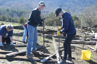 Emma Kane, works alongside classmate Nathan Seutter to deconstruct a damaged barn. 