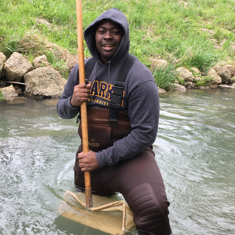Clarke University Environmental Studies program student at work in a local river.