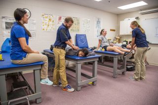 Students work on each other with feux injuries to practice proper techniques.