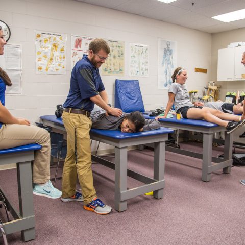 Students work on each other with feux injuries to practice proper techniques.