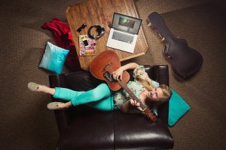 Overhead photo of Clarke Music Degree Student with a guitar