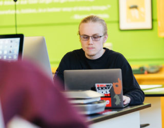 Clarke Communications Major in lab working on project