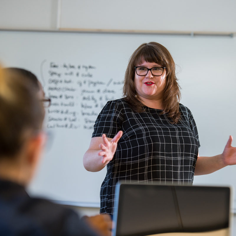 Clarke Professor Emily Goodmann teaching communications Majors in class