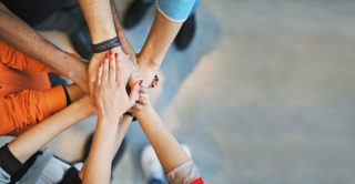 Clarke University social work degree students hands clasped in solidarity