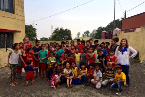 Clarke students with children while studying abroad in India