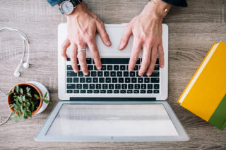 Clarke University History Degree student typing a paper